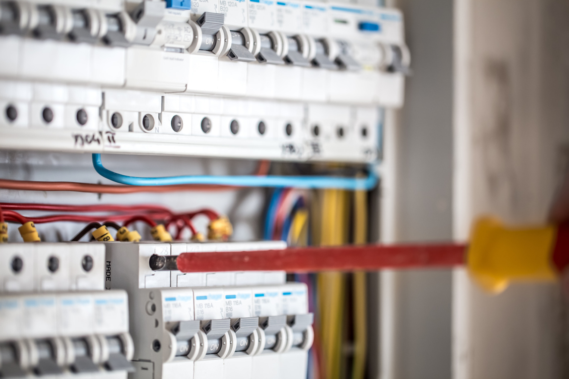 Electrical technician working on switchboard